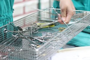 a hospital worker following hospital safety practices with hospital tools