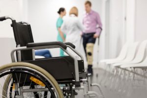 man walking from wheelchair