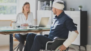 injured man in a wheelchair asking his workers compensation lawyer in New York how long he can receive workers comp benefits for