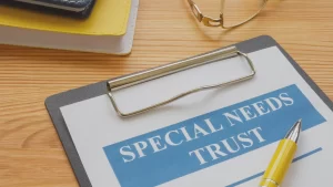 special needs trust document in a clipboard with a pen on top of it