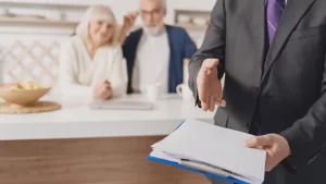 disability lawyer in new york holding a work history report document with his two clients in the back sitting down