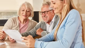 a happy elderly couple and their daughter reviewing a new york pension plan document