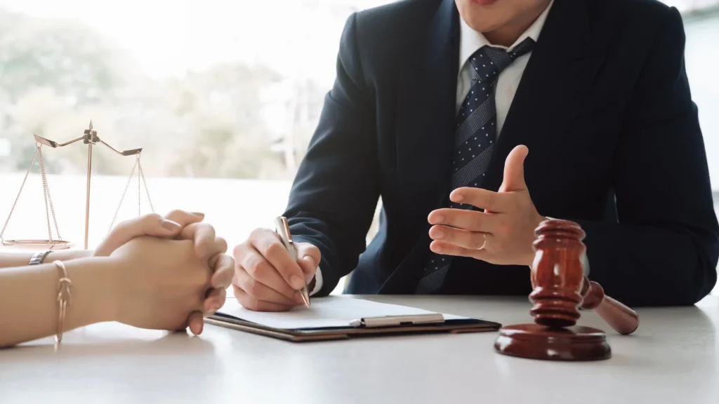 Lawyer and client discussing documents in a meeting.
