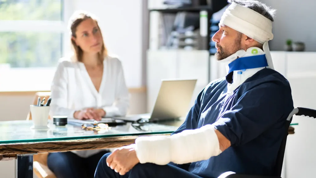 Injured man with bandages consulting a lawyer